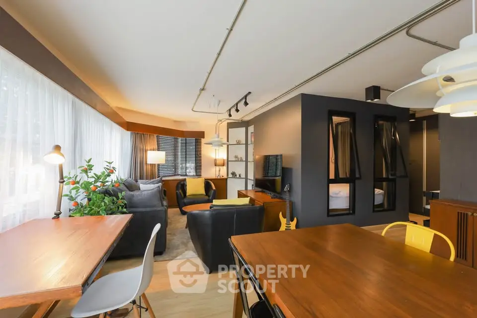 Modern open-plan living room with stylish decor and ample natural light.