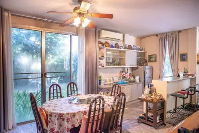 Charming dining area with garden view, featuring a cozy round table and elegant decor, perfect for family gatherings.