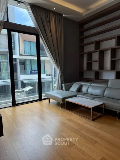 Modern living room with sleek leather sofa and large window view