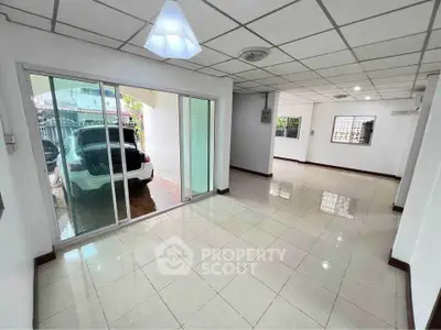 Spacious interior with tiled flooring and sliding glass doors, perfect for modern living.