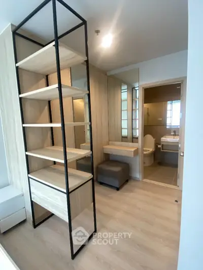 Modern bathroom with wooden shelving and sleek design