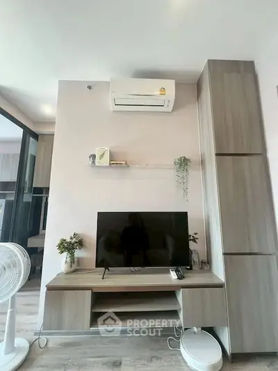 Modern living room with sleek TV stand and air conditioning unit