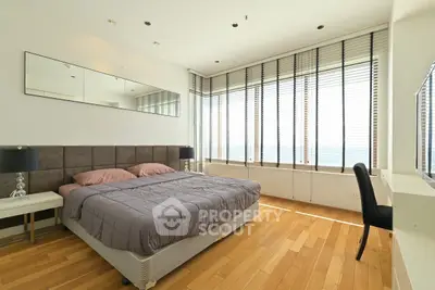 Spacious bedroom with ocean view and modern decor