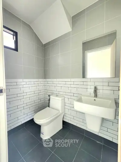Modern bathroom with sleek gray tiles and contemporary fixtures