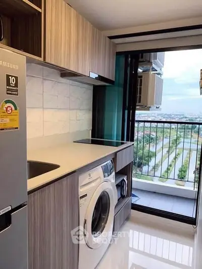 Modern kitchen with washing machine and balcony view in high-rise apartment