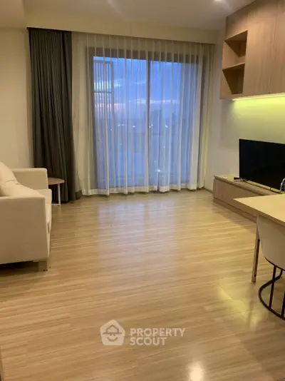 Modern living room with wooden flooring and large window view