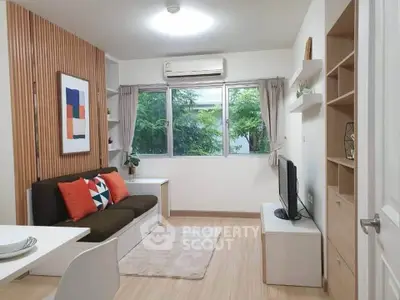 Modern living room with stylish decor, large window, and cozy seating area.
