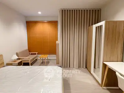 Modern bedroom with stylish furniture and large mirror wardrobe
