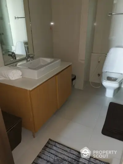 Modern bathroom with sleek fixtures and stylish vanity in a contemporary home.