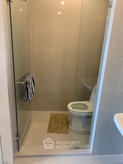 Modern bathroom with glass shower and sleek toilet design