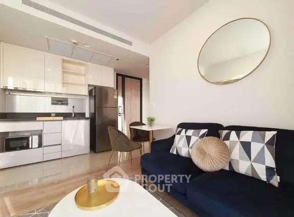 Modern open-plan living room with stylish kitchen and cozy seating area