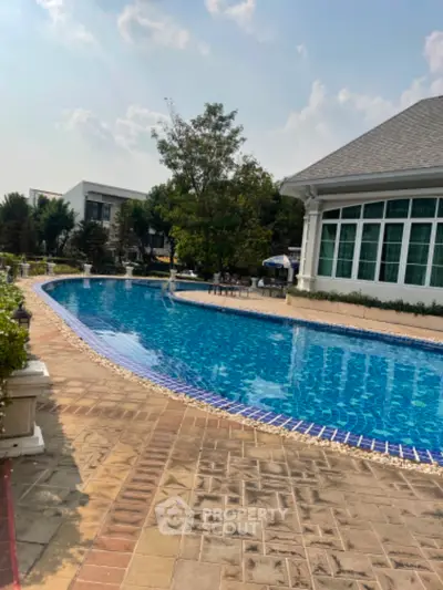Luxurious residential pool with elegant surroundings and clear blue water