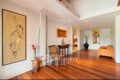 Spacious and elegant living area with wooden flooring and stylish decor