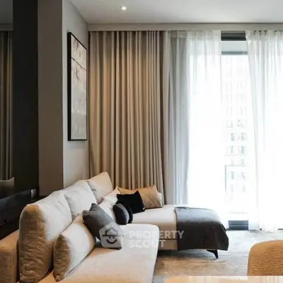 Luxurious modern living room with elegant sofa and floor-to-ceiling windows.