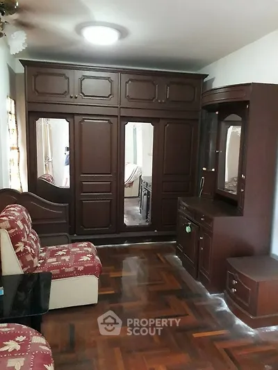 Spacious bedroom with elegant wooden furniture and parquet flooring