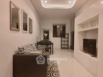 Modern living room with stylish decor and built-in entertainment unit