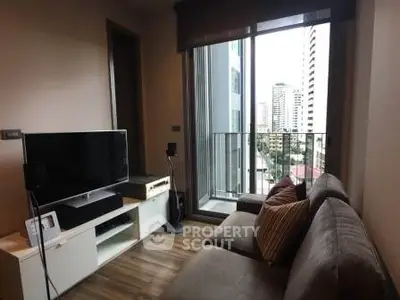 Modern living room with cozy sofa and city view balcony in high-rise apartment.
