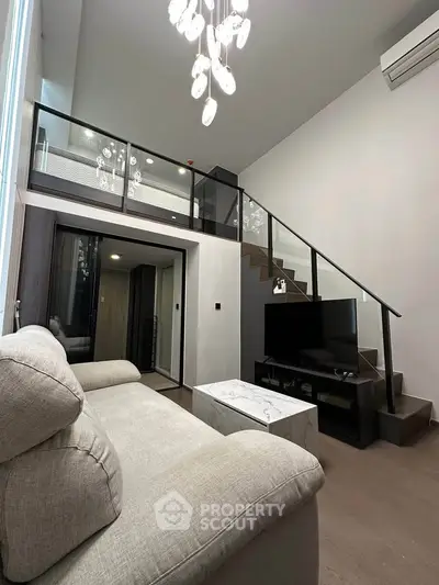 Modern loft-style living room with high ceilings and elegant chandelier