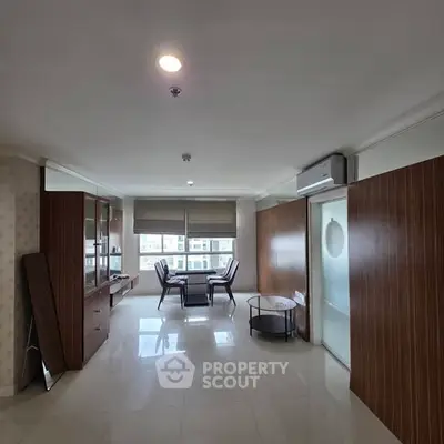 Spacious living room with modern furniture and large windows offering natural light.