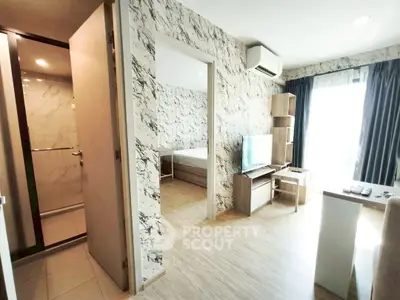 Modern apartment interior with marble walls and wooden flooring, featuring a cozy living area and bedroom.