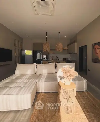 Spacious modern living room with stylish decor and open kitchen layout, perfect for contemporary living.