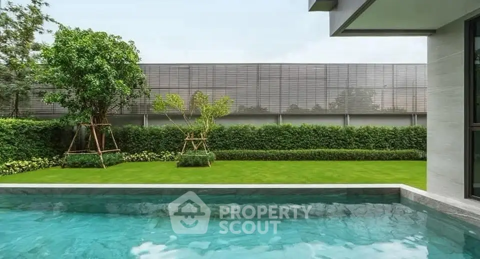 Luxurious private pool with lush garden in modern home setting