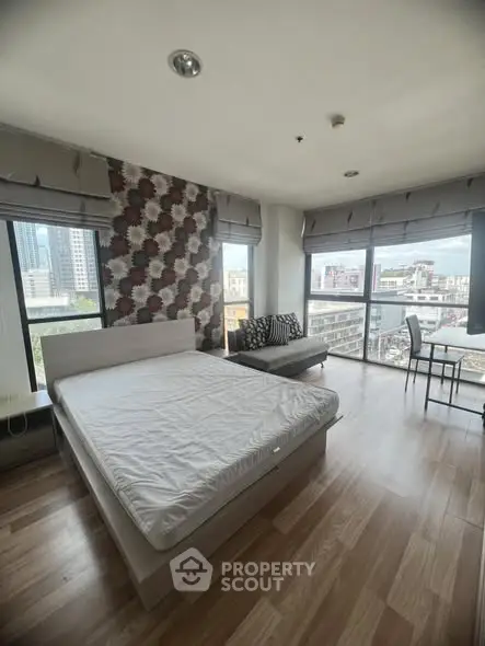 Spacious bedroom with city view and modern decor