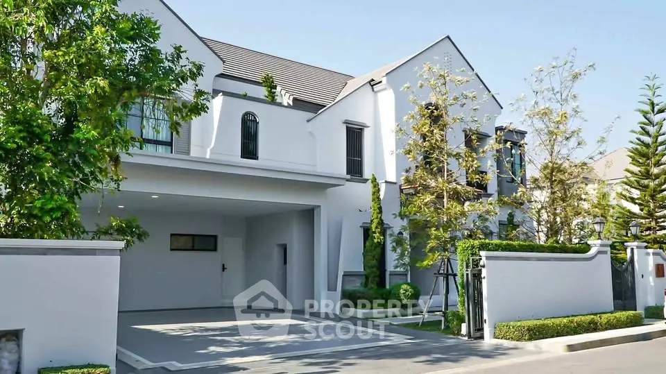 Elegant modern house exterior with lush greenery and spacious driveway