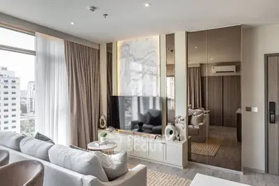 Luxurious modern living room with large windows and stylish decor in a high-rise apartment.