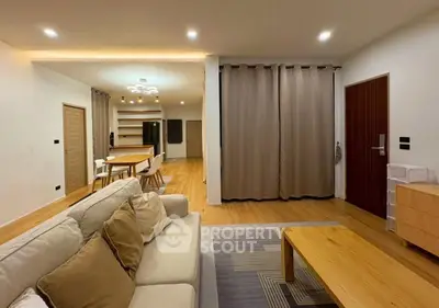 Spacious modern living room with open dining area and stylish decor