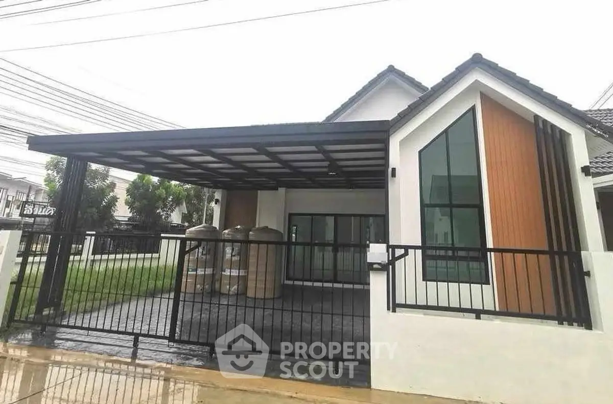 Modern single-story house with sleek design and spacious carport in a serene neighborhood.