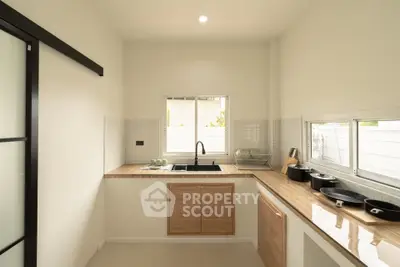 Modern kitchen with sleek countertops and ample natural light