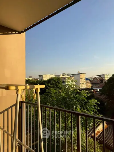 Charming balcony with scenic city view and lush greenery, perfect for relaxation.