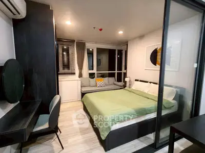 Modern bedroom with stylish decor and large window for natural light.