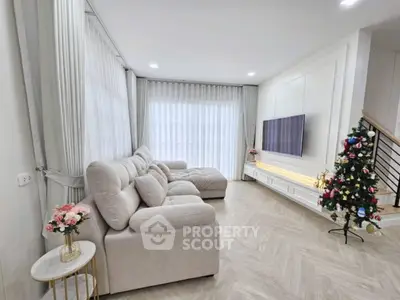 Spacious living room with elegant decor and a cozy sofa, perfect for relaxation.