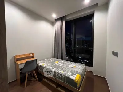 Modern bedroom with city view, featuring a cozy single bed and study desk, perfect for urban living.