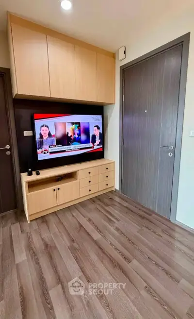 Modern living room with wooden flooring and built-in TV cabinet