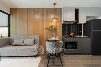Modern open-layout kitchen and living room with stylish decor and cozy seating area.