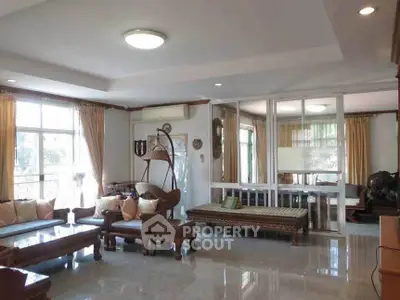 Spacious living room with elegant wooden furniture and large windows