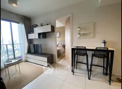 Modern living room with stylish furniture and city view, open layout leading to cozy bedroom.