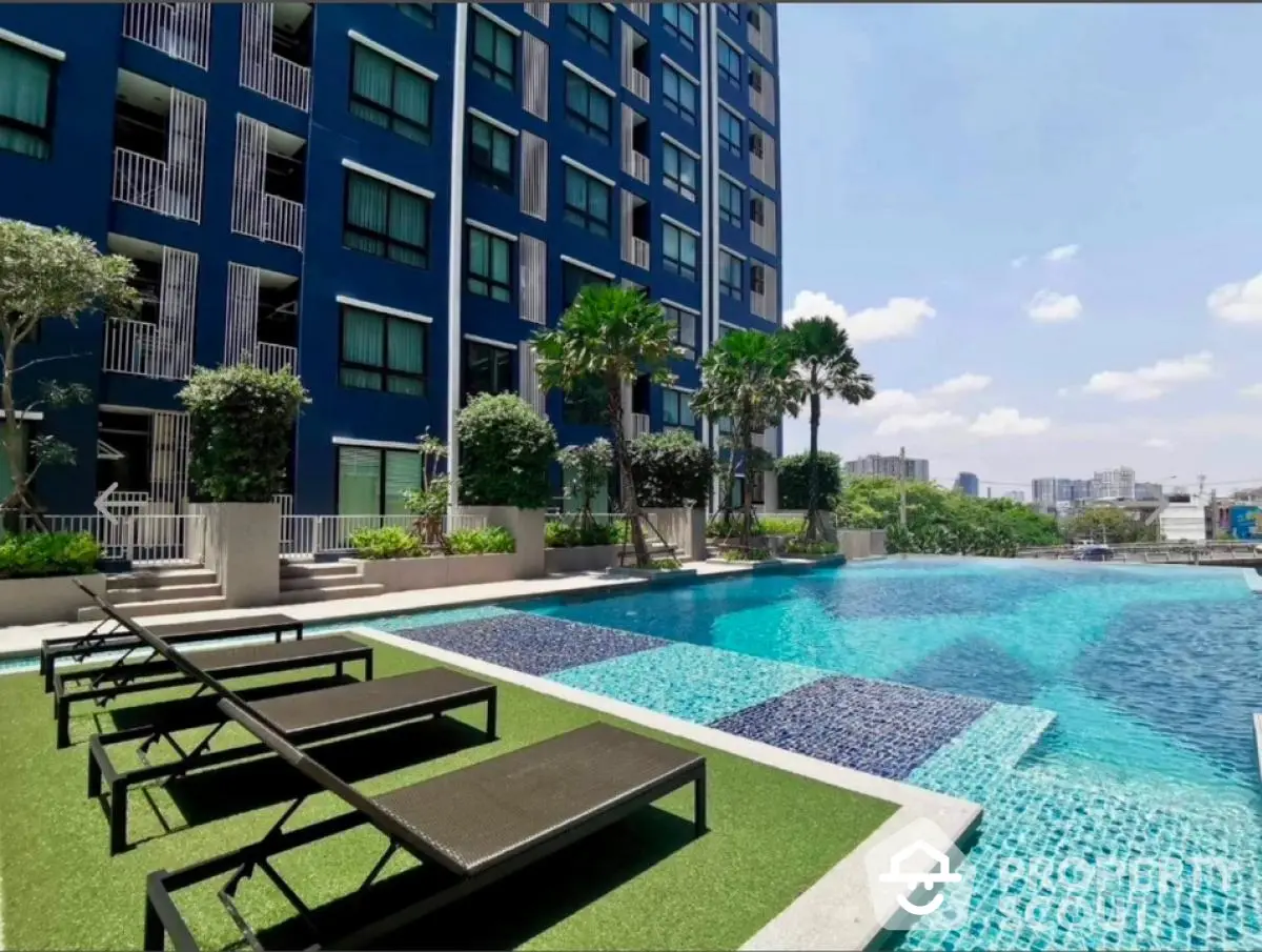 Luxurious apartment complex with stunning pool and city view, perfect for relaxation and leisure.