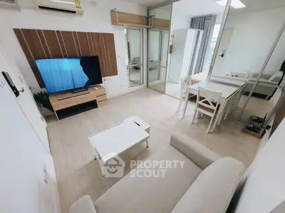 Modern living room with stylish decor, featuring a cozy sofa, flat-screen TV, and dining area in an open layout.