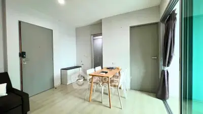 Modern dining area with sleek table and chairs, adjacent to a cozy living space, perfect for urban living.