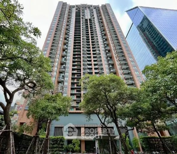 Stunning high-rise building with lush greenery and modern architecture in urban setting.