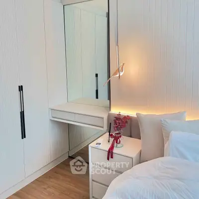 Modern bedroom with sleek white furniture and elegant lighting