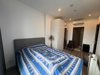 Cozy bedroom with modern decor and air conditioning in a stylish apartment.