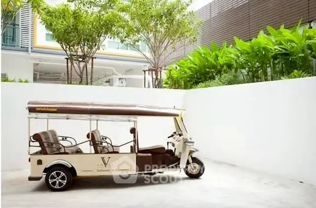 Charming outdoor area with lush greenery and unique vehicle, perfect for a vibrant community lifestyle.