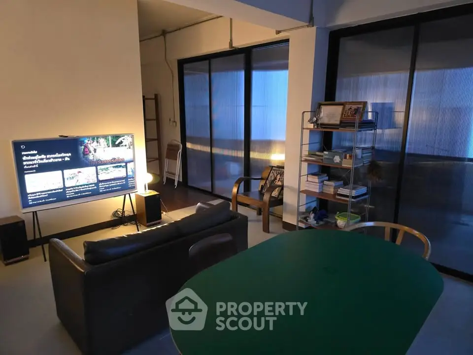 Modern living room with sleek furniture and large windows for natural light.