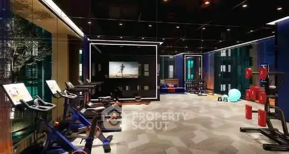 Luxurious modern gym with state-of-the-art equipment and ambient lighting in a high-end residential building.