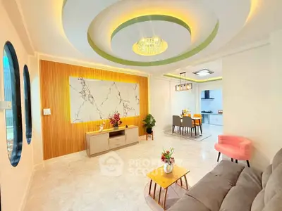 Modern living room with stylish decor and open layout to dining area and kitchen.